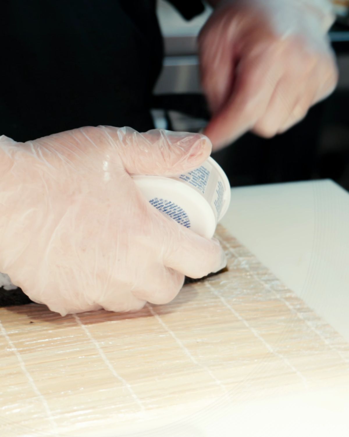 A chef rolling sushi by hand